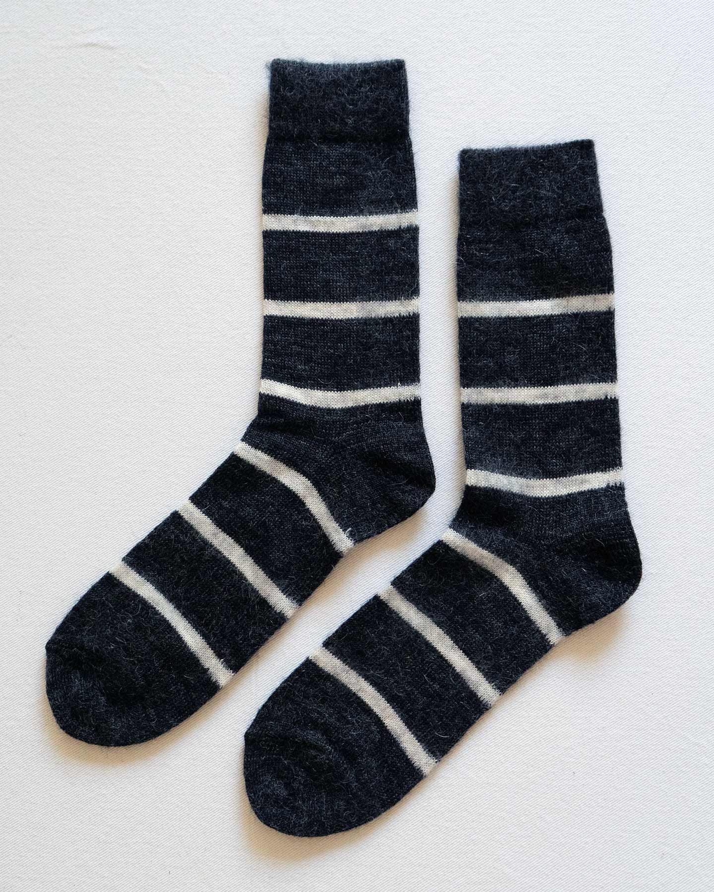 Pyne and Smith Clothiers Charcoal Stripe Mohair Wool Socks, shown laid flat side by side, feature white horizontal stripes and provide a warm yet lightweight feel.