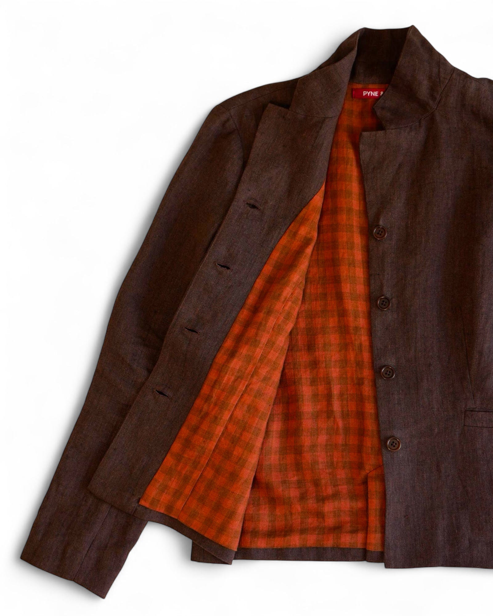 The Pyne and Smith Clothiers Tailored Linen Jacket No.10 in Worcestershire, a dark brown tailored fit, is shown open to display its orange plaid inner lining against a white background.