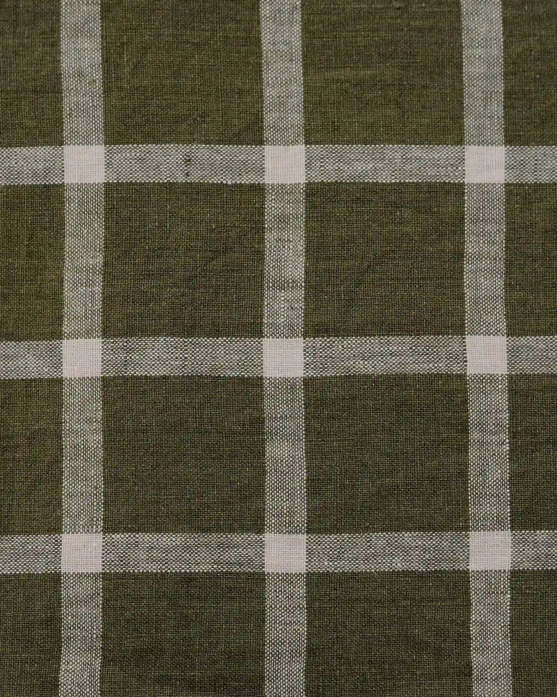 A close-up of the olive green and white Celtic Plaid linen on the No.17 Full Length Linen Tea Dress by Pyne and Smith Clothiers, showing its intersecting checkered pattern.