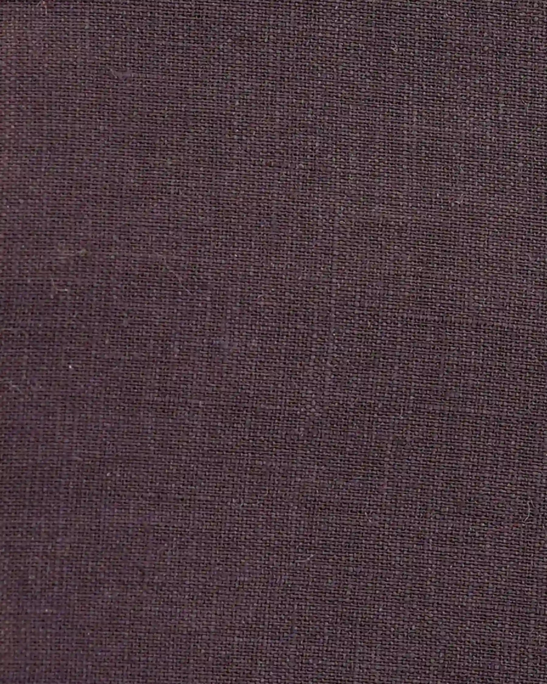 Close-up of the Pyne and Smith Clothiers Linen Maxi Skirt No.12 in Chocolate Plum, highlighting its dark brown European linen fabric with a subtle, textured weave and visible intersecting threads.