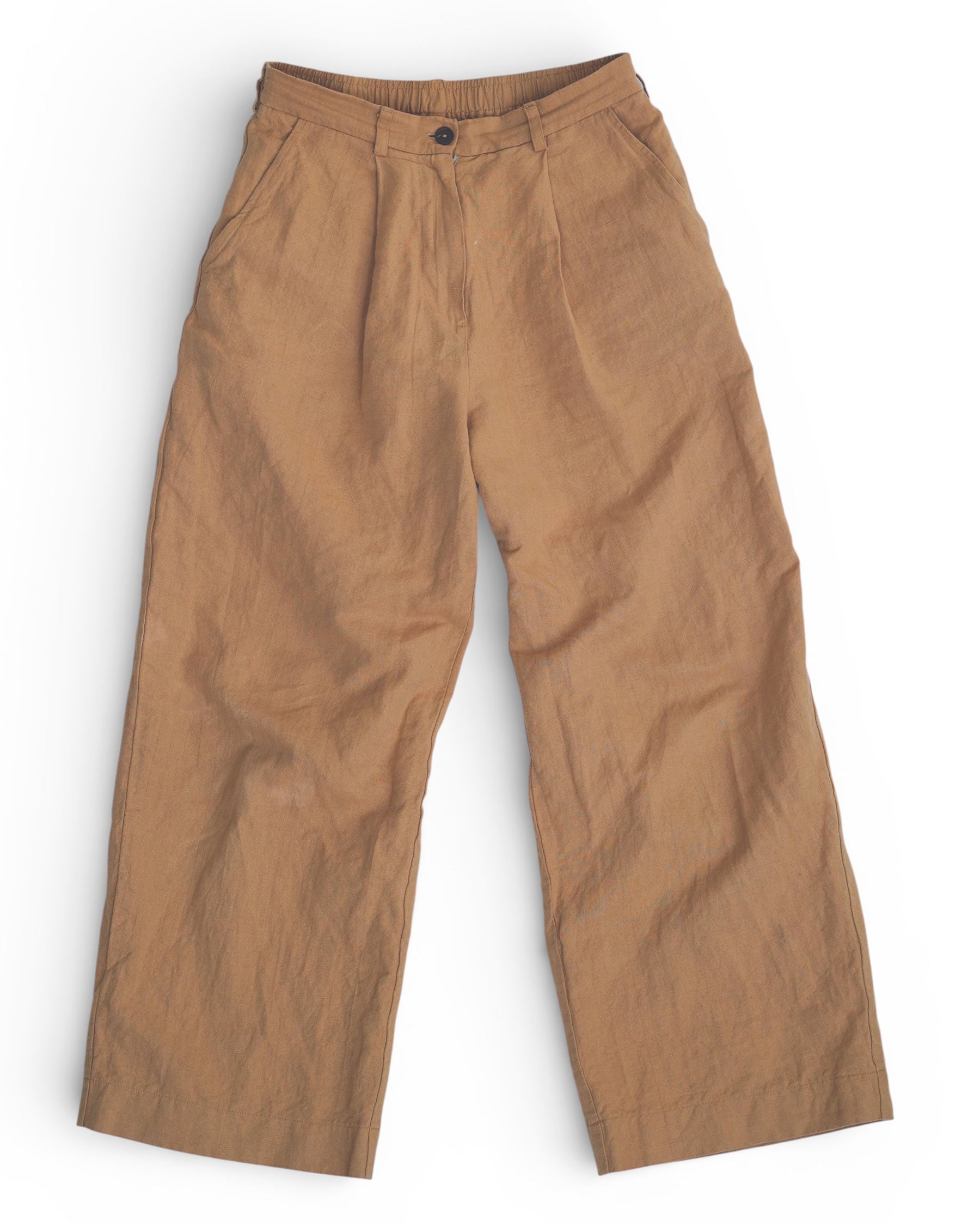 The Cotton Linen Trousers No.16 in Lark Tan by Pyne and Smith Clothiers are high-waisted, wide leg pants with front pleats, button closure, and belt loops, shown laid flat on a white background.