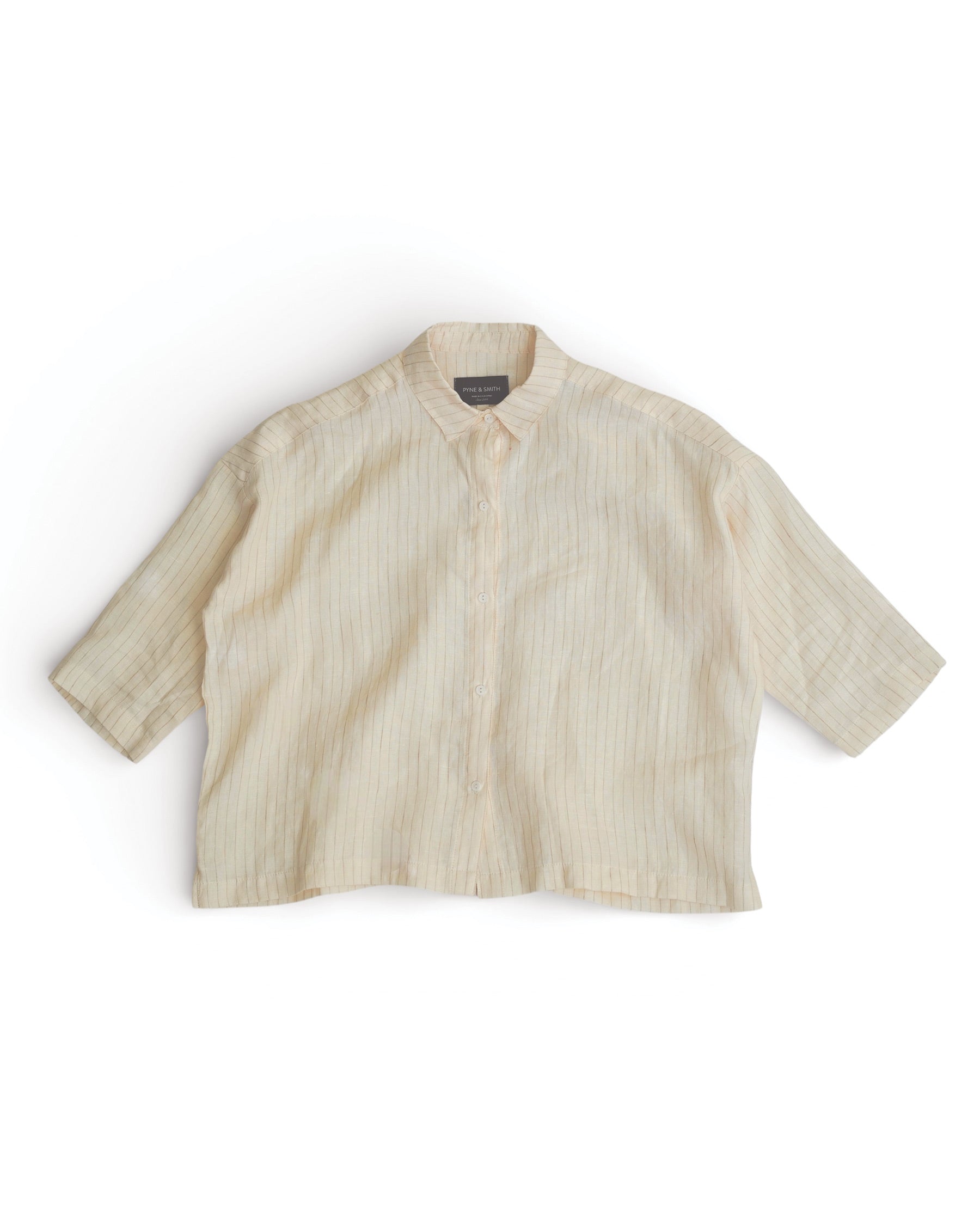 The Boxy Cropped Linen Blouse No.22 in Cream Pinstripe by Pyne and Smith Clothiers features short sleeves, a boxy button-up style with vertical stripes, a collar, and a loose cropped fit, shown on a white background.