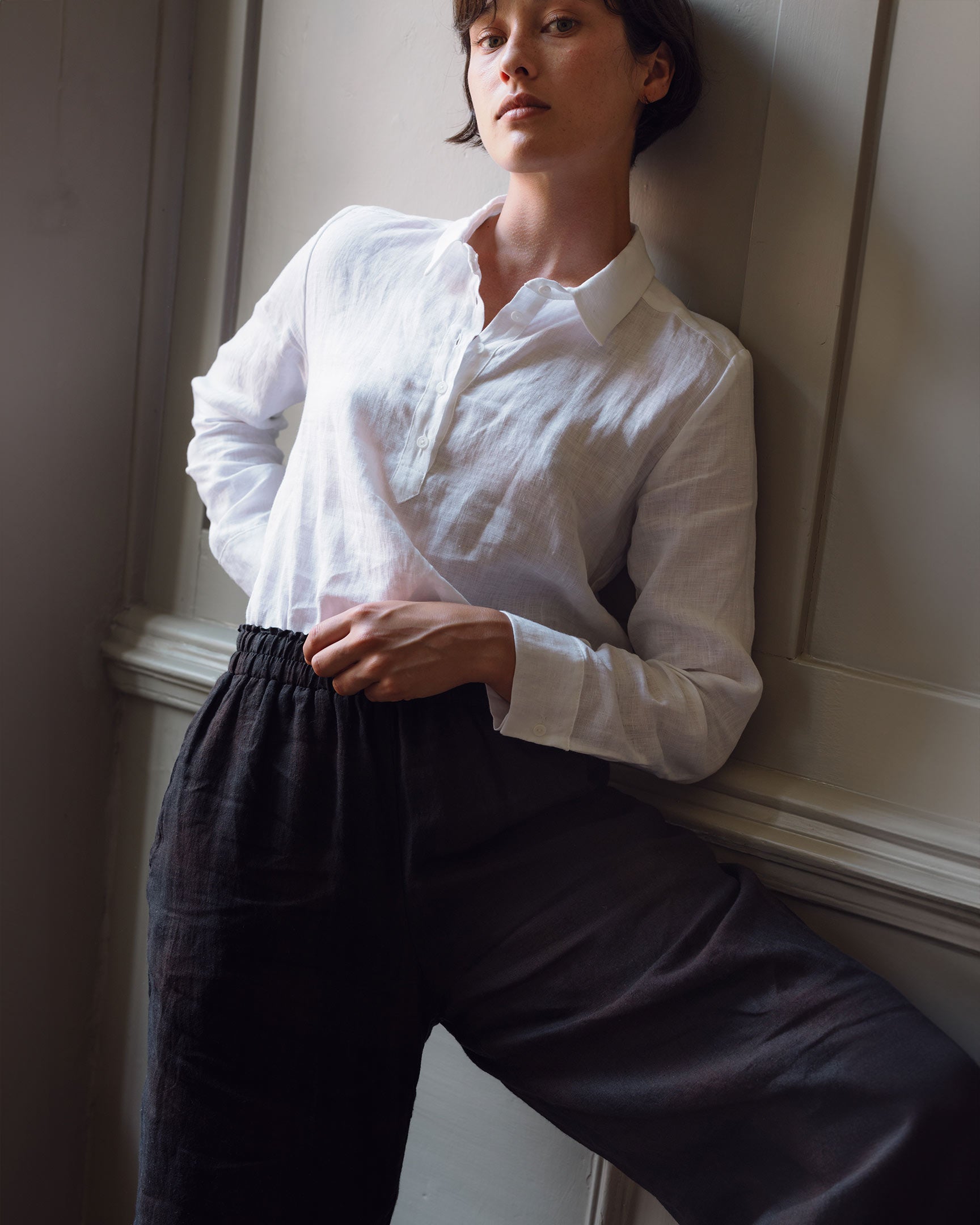 Close up of model wearing black linen culottes with white linen blouse