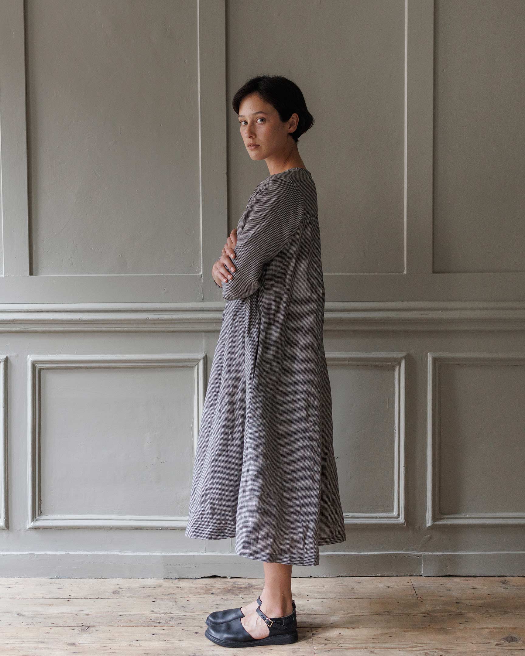 Side view of model wearing no. 35 A line linen dress in Hazlitt's Check showing flowing silhouette