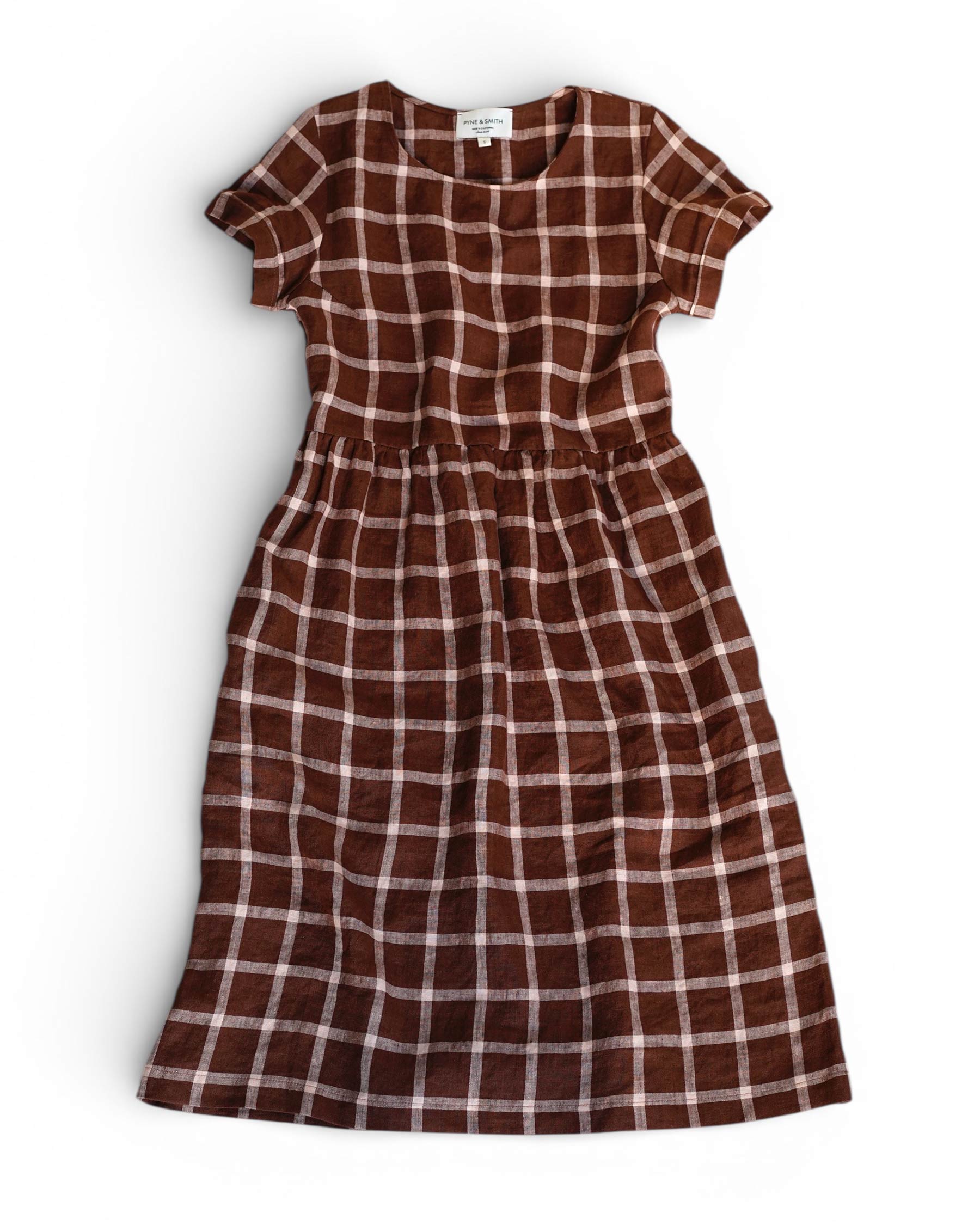 Brown and pink checkered dress on a white background