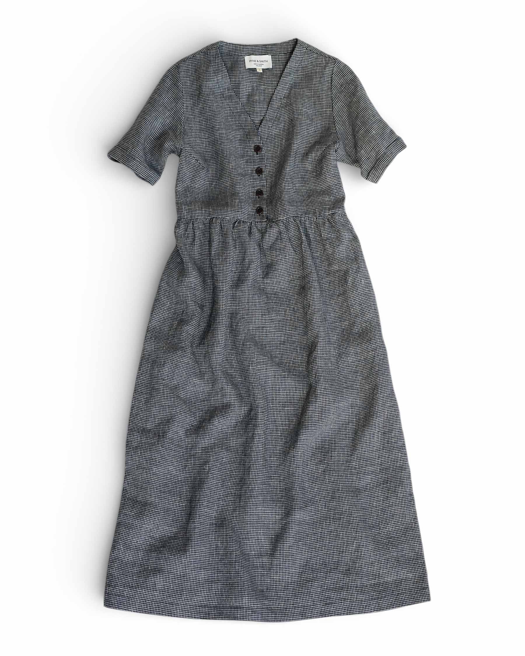 The No.31 V Neck, Full Length Linen Dress in Brasserie Check by Pyne and Smith Clothiers features short sleeves, a gathered waist, and front buttons, shown laid flat on a white background.