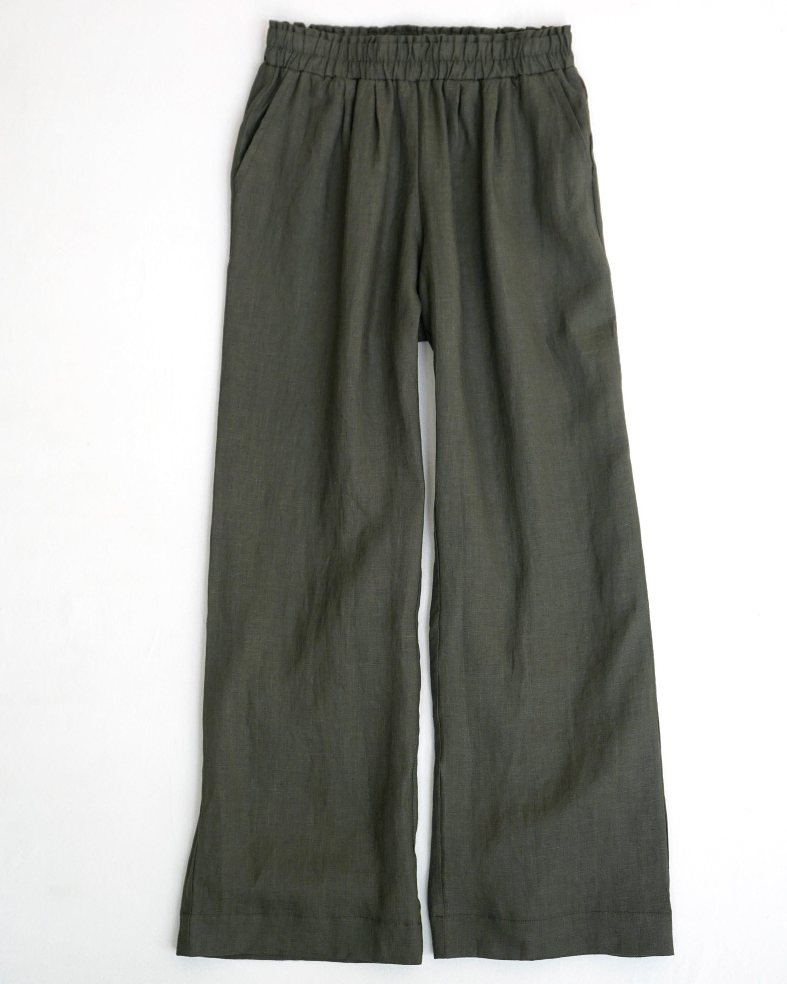 The Pyne and Smith Clothiers Linen Lounge Pants No.12 in Beetle Green are wide-leg, sustainably made linen pants with an elastic waistband and side pockets, shown laid flat on a white background.