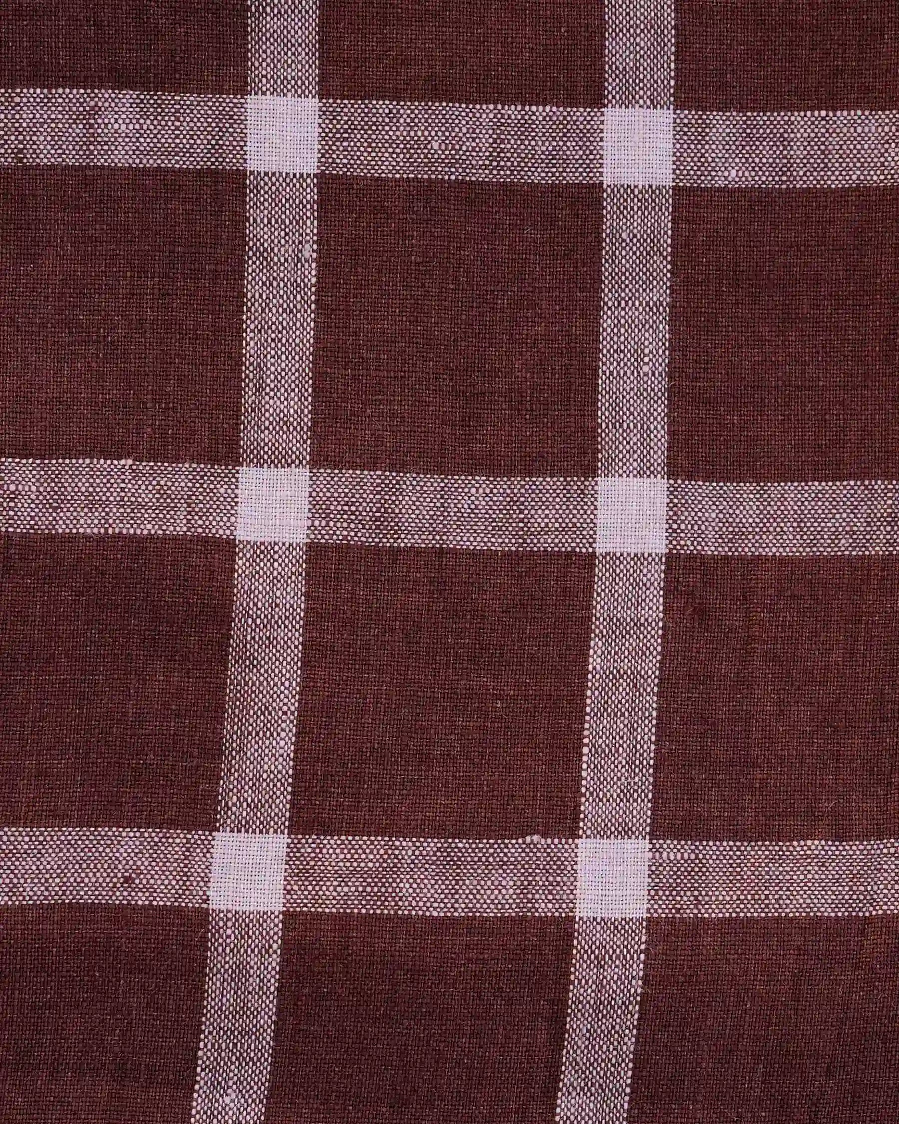 The Linen Skirt No.11 in Neapolitan by Pyne and Smith Clothiers features brown European flax linen with a white plaid pattern of large, evenly spaced squares—ideal for an elegant and timeless look.