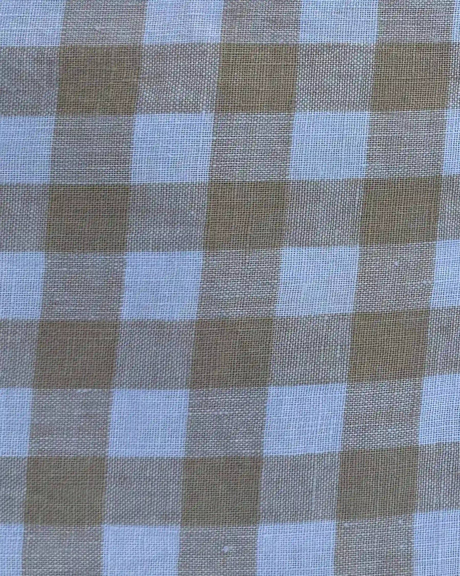 Close-up of the St. Agnes Check fabric from Pyne and Smith Clothiers’ No.24 Sleeveless, button up Linen Dress, showcasing alternating light brown and white squares with a woven texture perfect for breezy summer wear.
